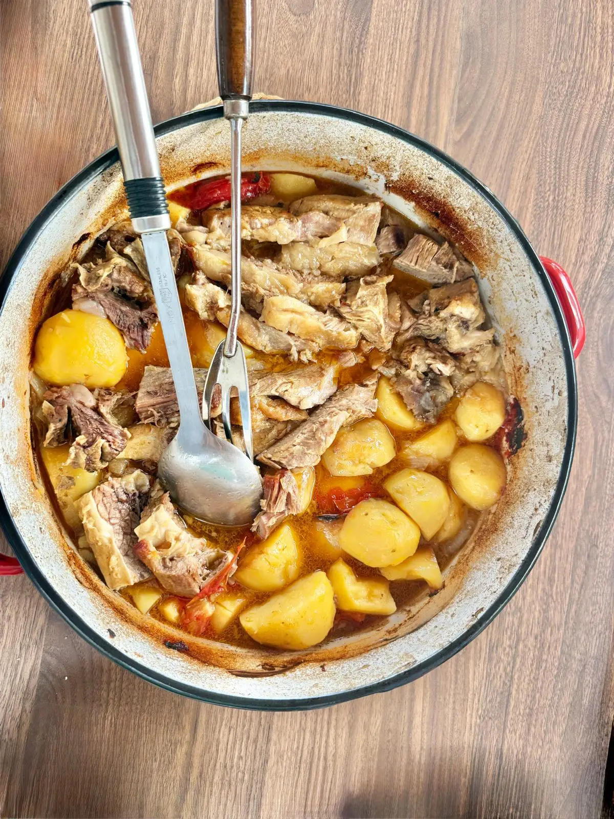 Traditional peka dish with meat and potatoes slow-cooked in a large pot
